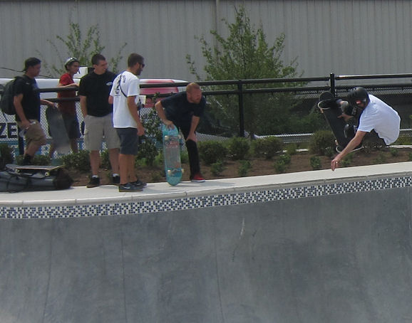 Tony pops a BIG tweaked ollie to fakie as pro Chet Childress looks on.